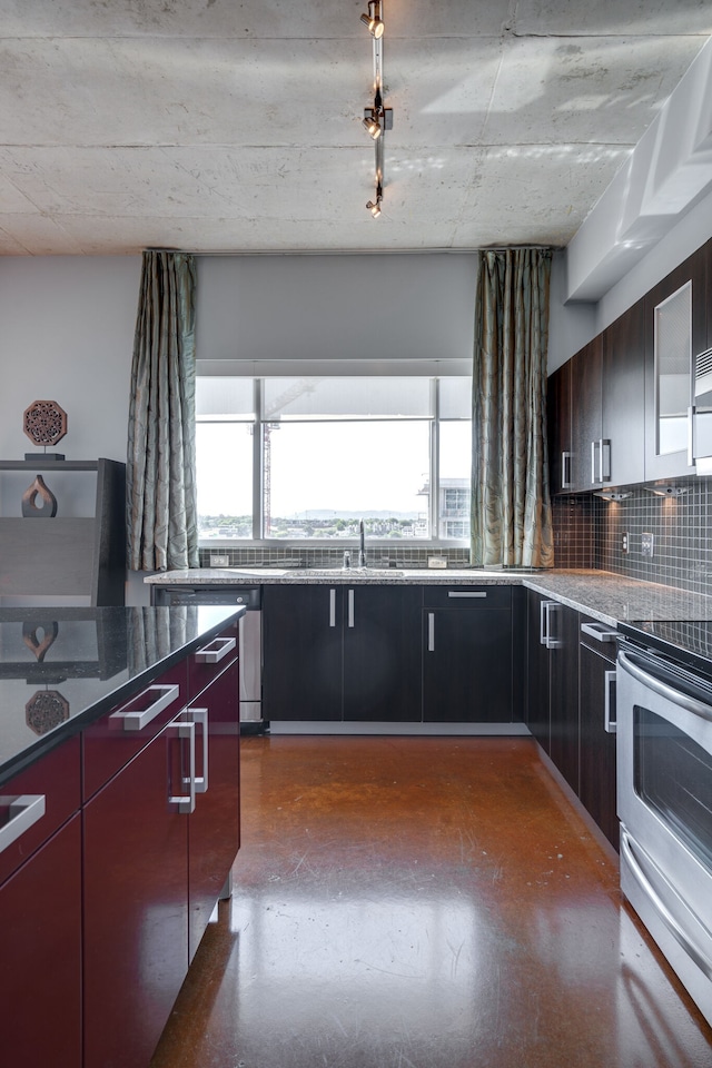 kitchen featuring dark stone countertops, tasteful backsplash, sink, and electric range