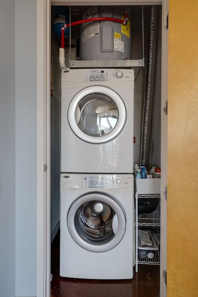 clothes washing area with stacked washing maching and dryer