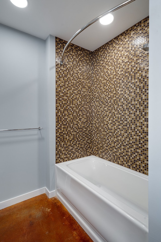 bathroom featuring tiled shower / bath and concrete floors