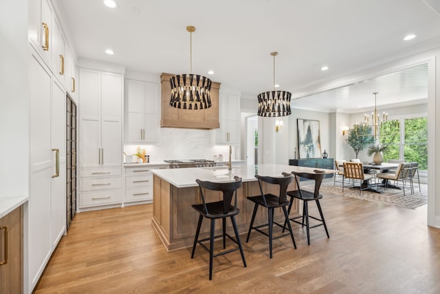 kitchen with light wood-type flooring and white cabinetry