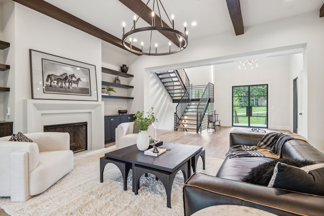 living room with hardwood / wood-style flooring, an inviting chandelier, and beam ceiling