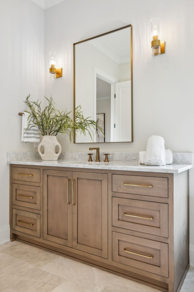 bathroom with tile patterned flooring, crown molding, and vanity