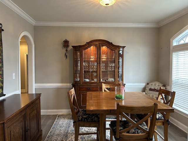 dining space with crown molding and dark hardwood / wood-style floors