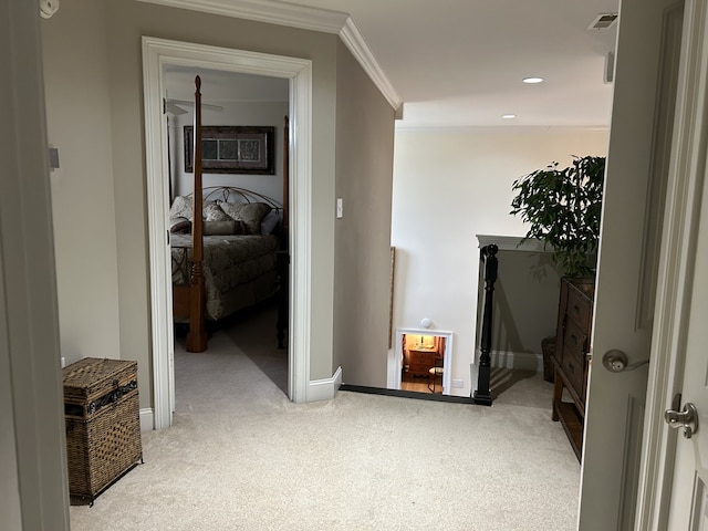 corridor featuring ornamental molding and light carpet