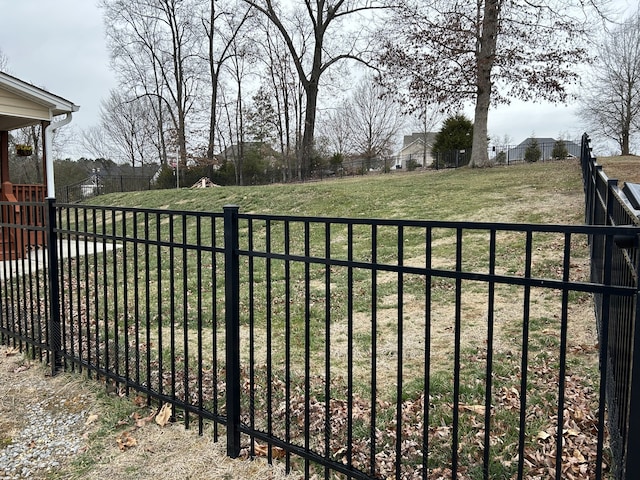 view of gate featuring a lawn