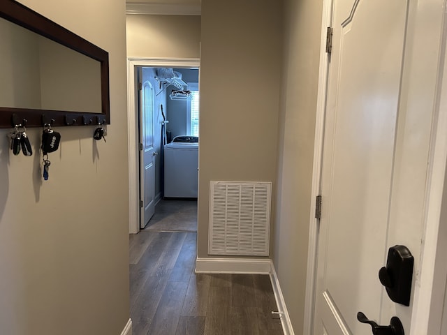 corridor featuring washer / clothes dryer and dark hardwood / wood-style flooring