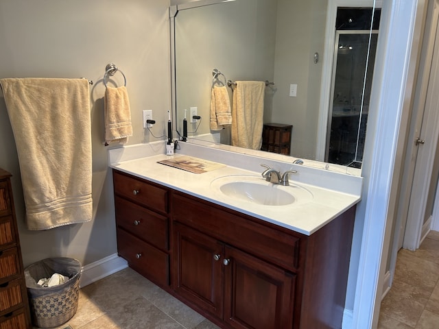 bathroom featuring a shower with shower door, tile patterned flooring, and vanity