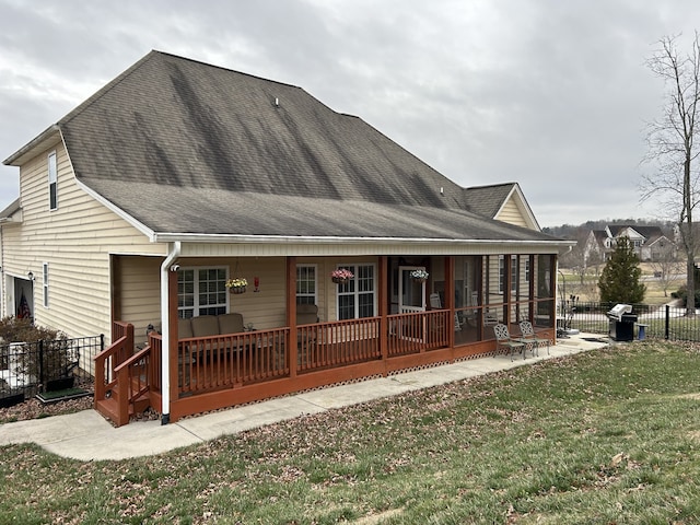 back of house featuring a lawn and a patio