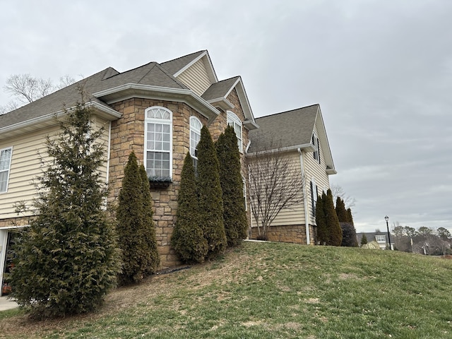 view of side of home featuring a lawn