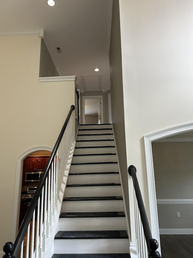 stairs with crown molding, visible vents, baseboards, and recessed lighting