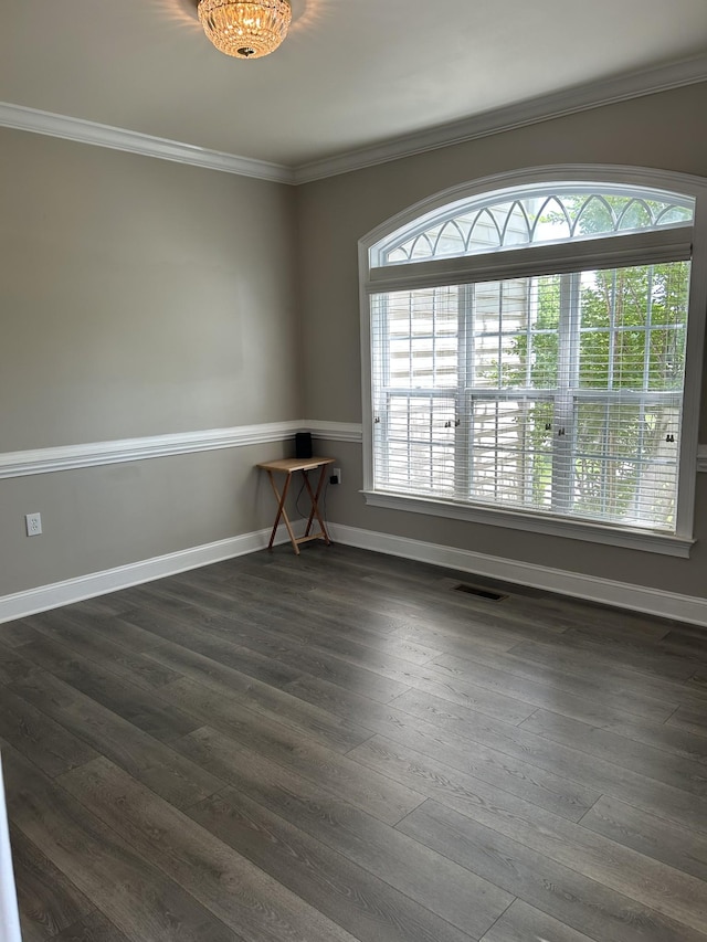 unfurnished room featuring ornamental molding, plenty of natural light, and visible vents