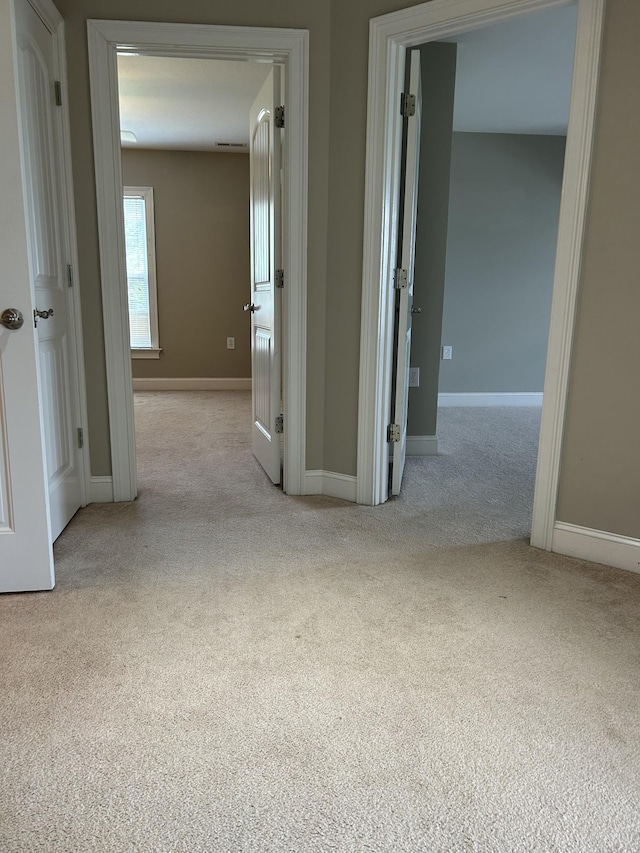 carpeted empty room with baseboards