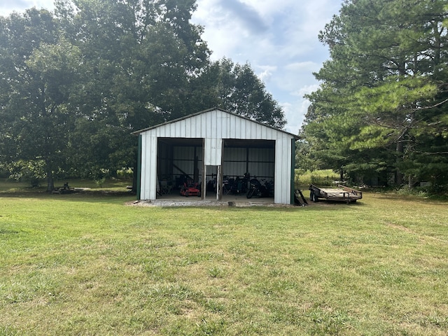 view of outdoor structure featuring a yard and a garage