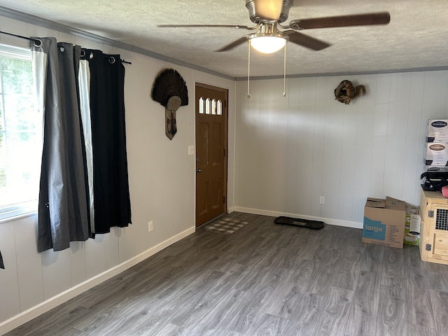 unfurnished room featuring ceiling fan, hardwood / wood-style flooring, crown molding, and a textured ceiling