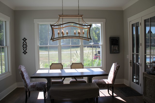 dining space featuring crown molding and hardwood / wood-style flooring