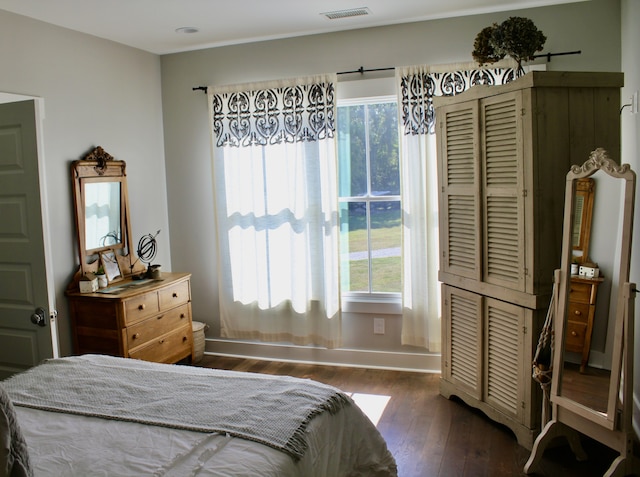 bedroom with dark wood-type flooring