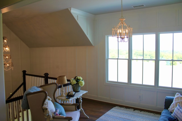 sitting room featuring dark wood-type flooring and a chandelier