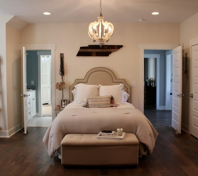 bedroom with dark wood-type flooring and an inviting chandelier