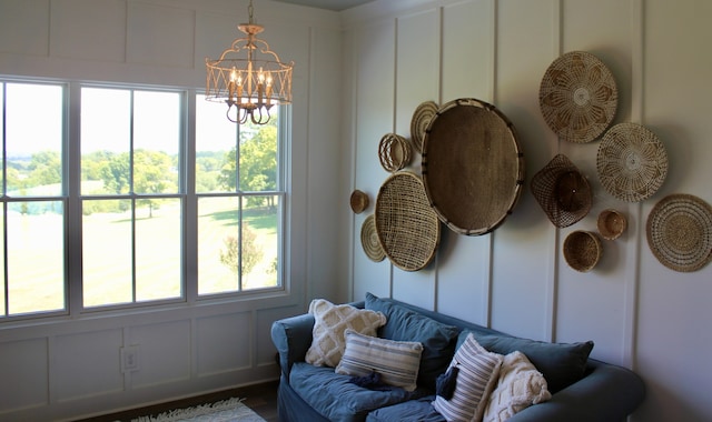 sunroom / solarium with a notable chandelier