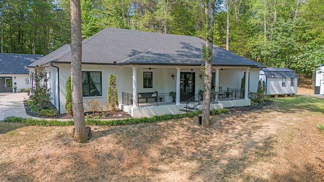 view of front of property featuring a storage unit and a porch