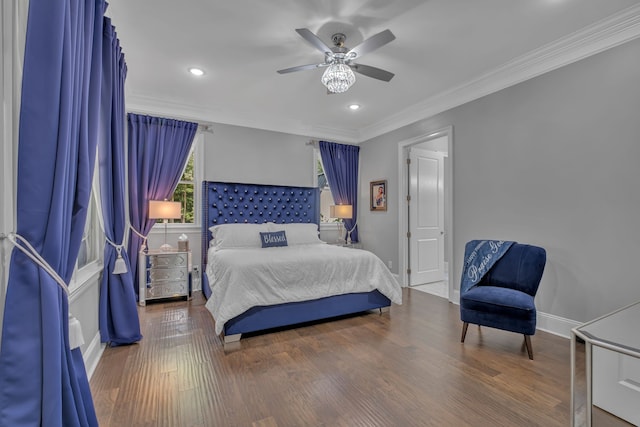 bedroom with crown molding, ceiling fan, and dark hardwood / wood-style floors