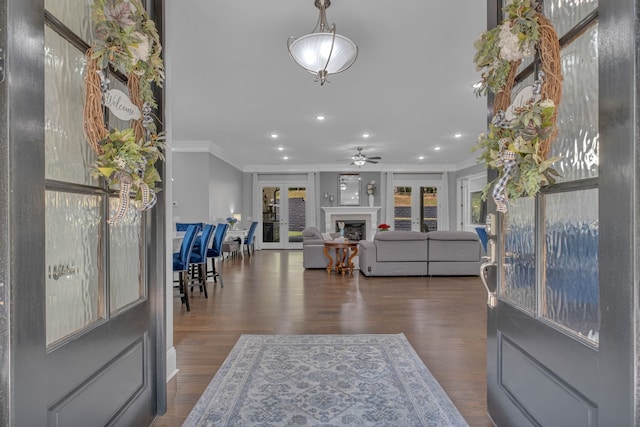 entryway with ornamental molding, ceiling fan, and dark hardwood / wood-style floors