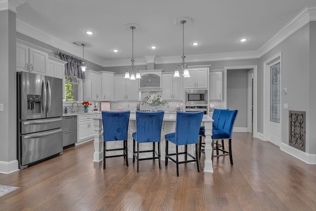 kitchen with white cabinets, a center island, stainless steel appliances, and dark hardwood / wood-style floors