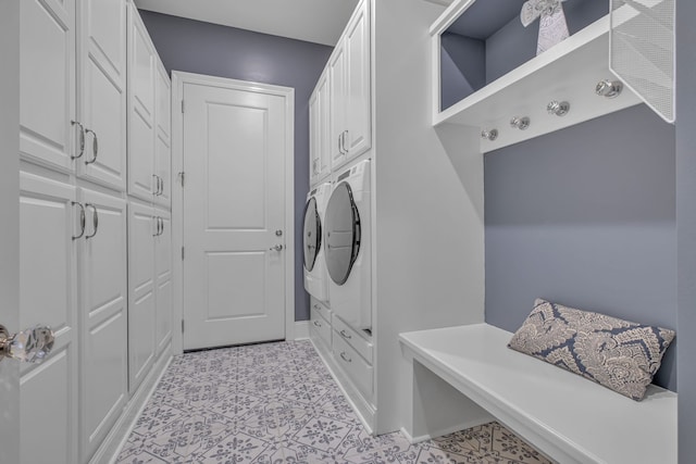 laundry area with washer / dryer and cabinets