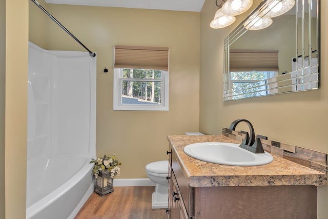 full bathroom featuring vanity, toilet, bathtub / shower combination, and hardwood / wood-style flooring