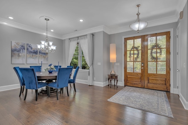 dining area featuring an inviting chandelier, dark hardwood / wood-style flooring, and ornamental molding