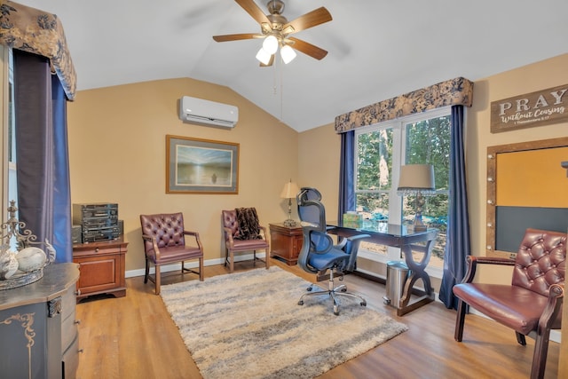 home office featuring light wood-type flooring, vaulted ceiling, an AC wall unit, and ceiling fan