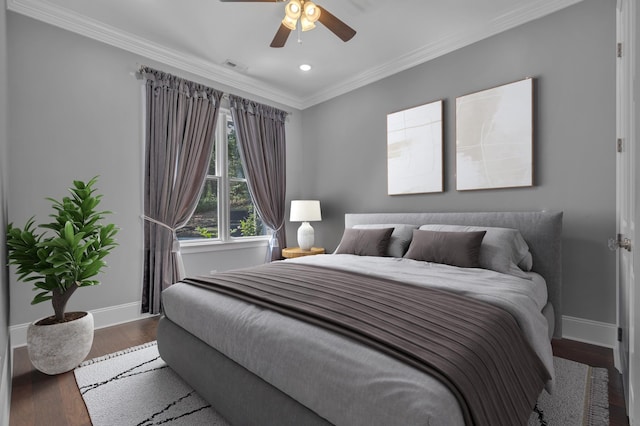 bedroom featuring ceiling fan, ornamental molding, and hardwood / wood-style flooring