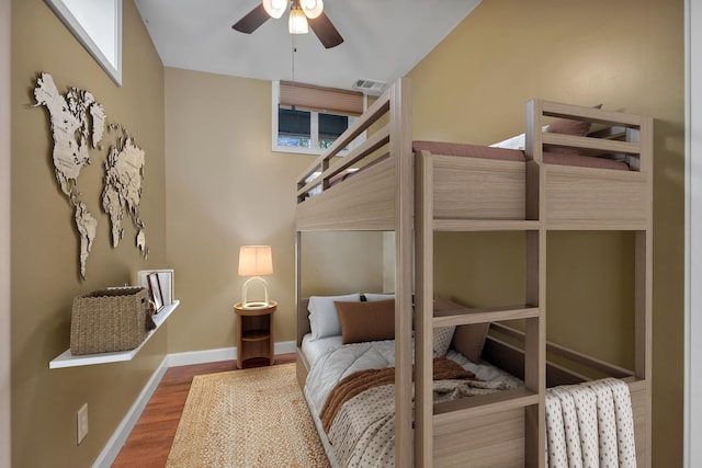 bedroom with ceiling fan and wood-type flooring