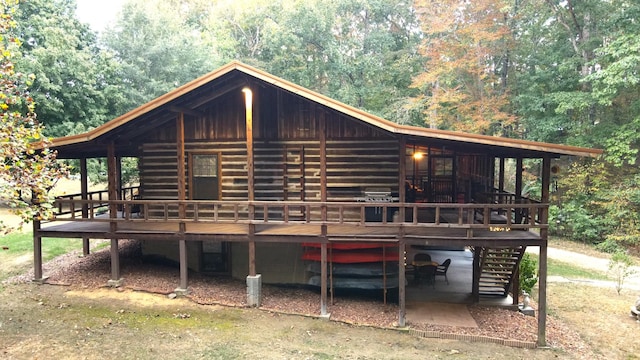 450 Pinson Ln, Big Sandy, TN 38221 - rear view of house with a wooden deck and a forest view