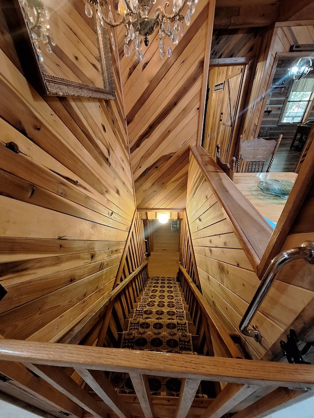450 Pinson Ln, Big Sandy, TN 38221 - stairs with wooden walls and a notable chandelier