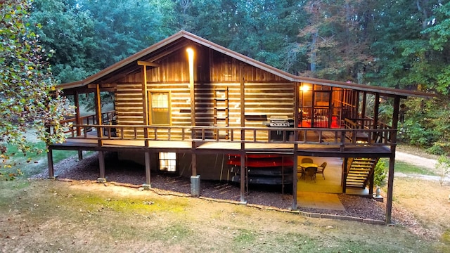 450 Pinson Ln, Big Sandy, TN 38221 - back of property with a wooden deck and a forest view
