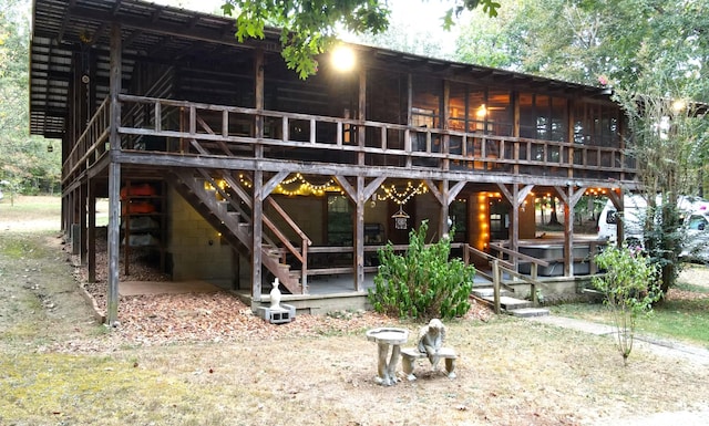 450 Pinson Ln, Big Sandy, TN 38221 - back of house featuring a wooden deck and stairs
