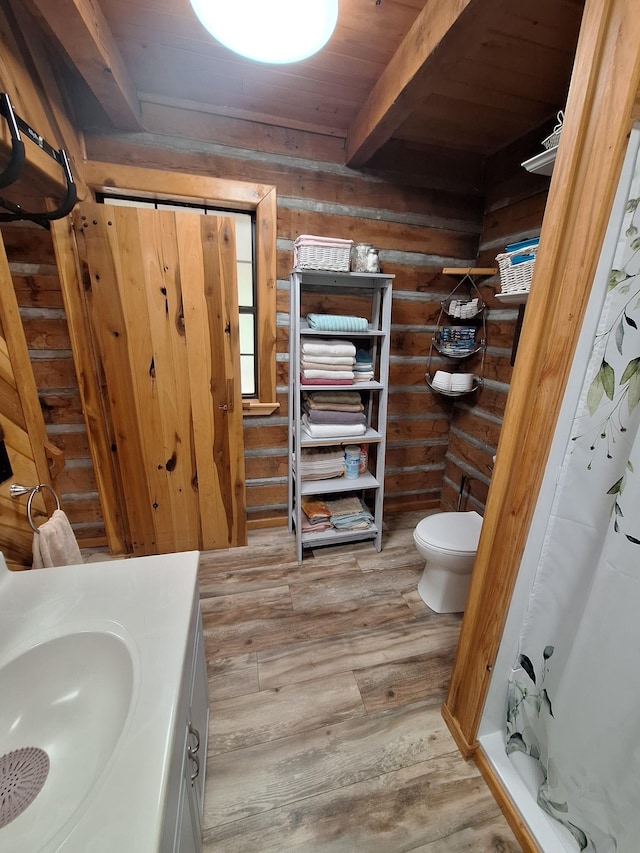 450 Pinson Ln, Big Sandy, TN 38221 - bathroom featuring toilet, beamed ceiling, wood finished floors, curtained shower, and vanity