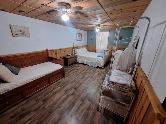 450 Pinson Ln, Big Sandy, TN 38221 - bedroom with wainscoting, wooden walls, wood finished floors, and ceiling fan