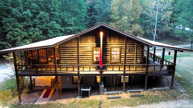 450 Pinson Ln, Big Sandy, TN 38221 - rear view of house featuring cooling unit, a deck, and a wooded view