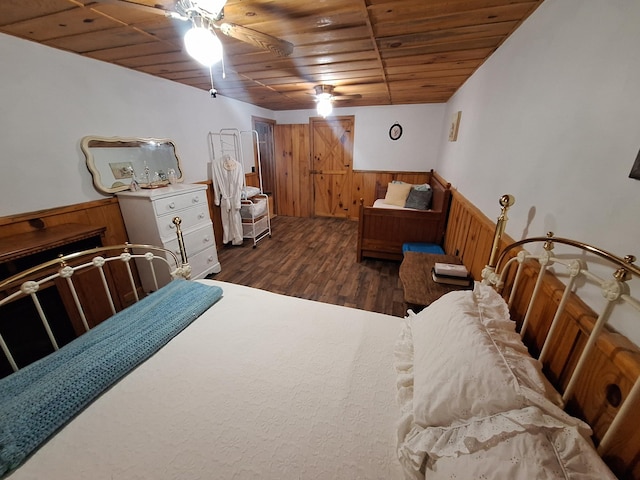 450 Pinson Ln, Big Sandy, TN 38221 - bedroom featuring a wainscoted wall, wood walls, wood finished floors, wooden ceiling, and ceiling fan