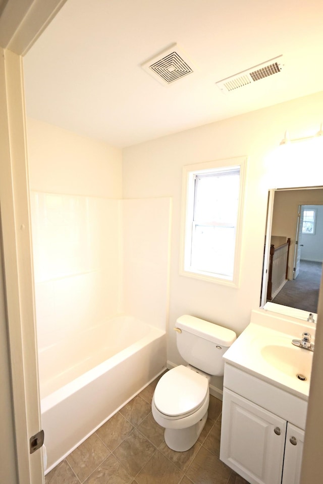 bathroom with visible vents, vanity, toilet, and tile patterned floors