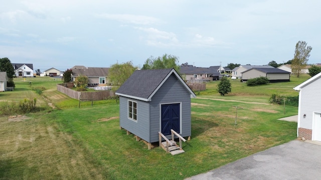 view of shed featuring fence and a residential view