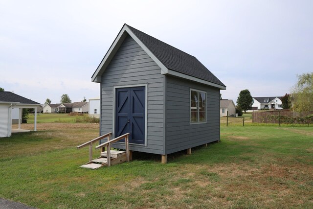 view of outdoor structure featuring a lawn