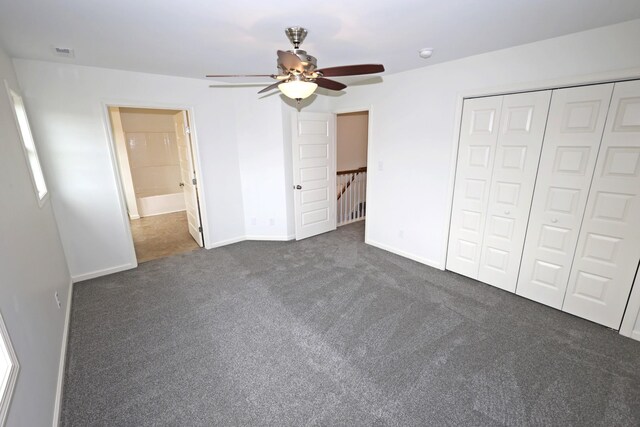 unfurnished bedroom with dark carpet, a closet, and ceiling fan