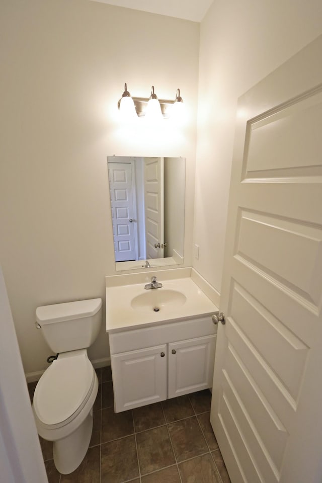 bathroom featuring toilet, tile patterned floors, and vanity