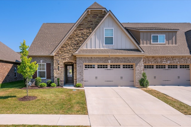 craftsman inspired home with a garage and a front lawn