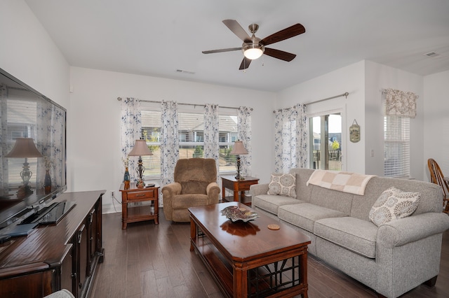 living room with ceiling fan and dark hardwood / wood-style floors