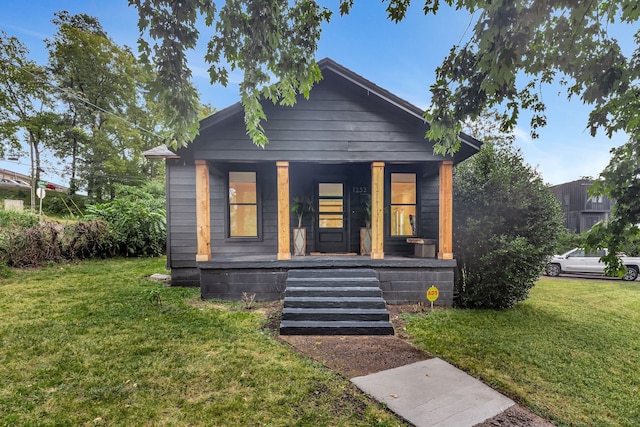 bungalow-style home with a porch and a front yard