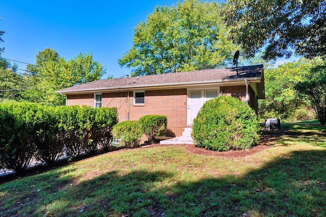 view of side of home with a yard